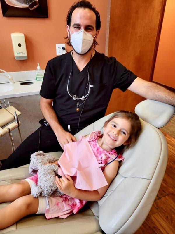 Doctor cleaning child teeth