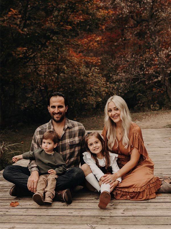 Dr. Berhard with his wife and 2 children sitting